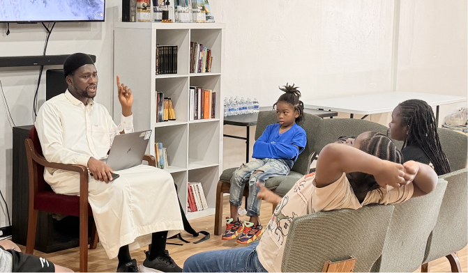 An Oak Cliff mentor leading a learning circle with young people