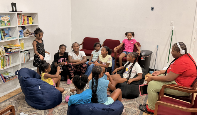 Young people gathered with their mentor at the Oak Cliff Empowerment Center